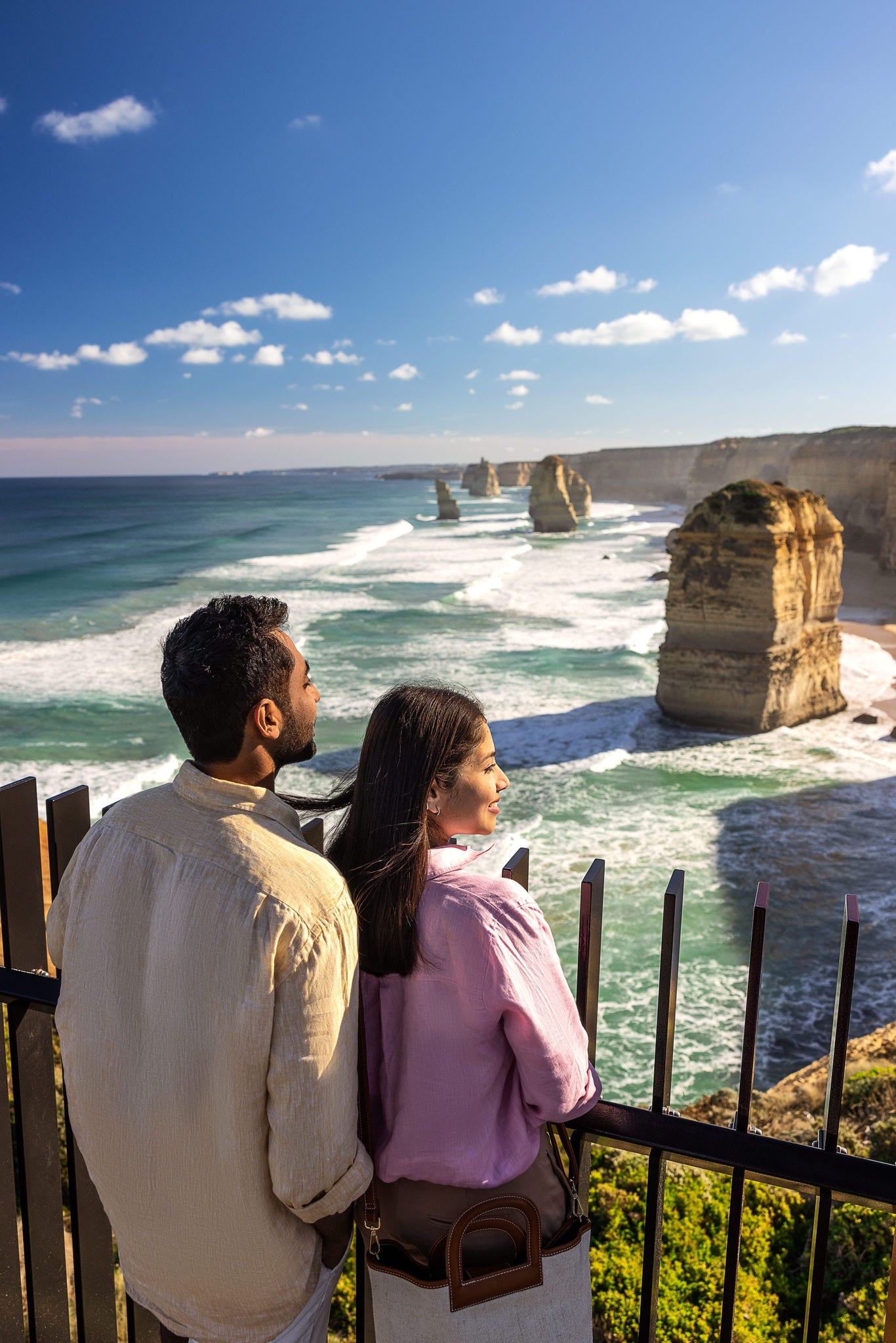 A couple looking out on the view over the ocean.